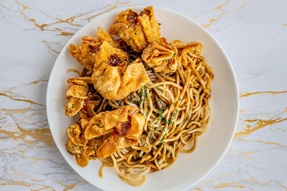 Stir-fry egg noodles topped with fried pork siomai